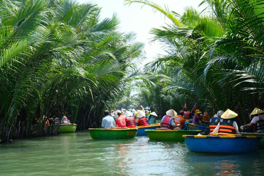 Tourists exploring Vietnam's lush jungle waterways in traditional basket boats.