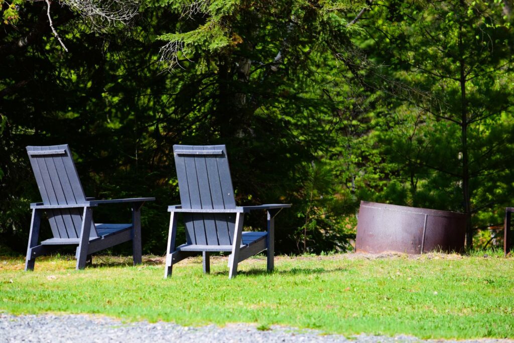 Peaceful outdoor setting with Adirondack chairs and a fire pit in Dinorwic, Ontario.