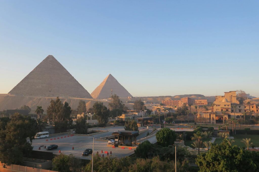 Stunning view of the Great Pyramids of Giza during sunrise, capturing an iconic Egyptian scene.