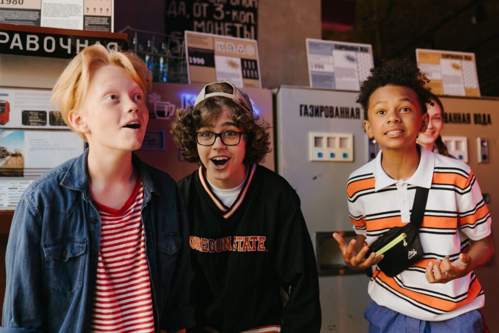 A group of diverse teenagers having fun and bonding indoors, showcasing friendship and excitement.