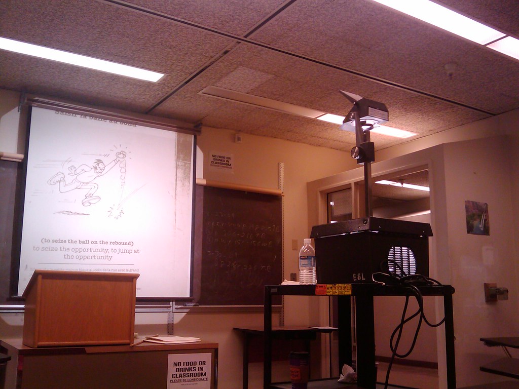 Old overhead projector in the classroom with transparency sheets