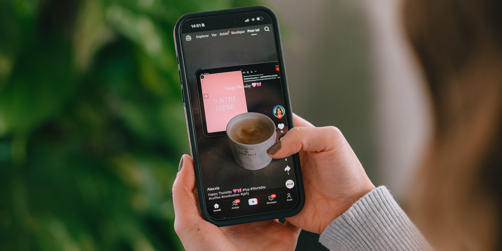 Person holding phone showing coffee cup on screen