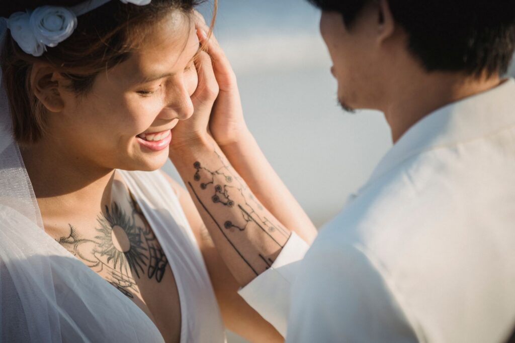 Close-up of a couple in love at a beach wedding, sharing a joyful moment.