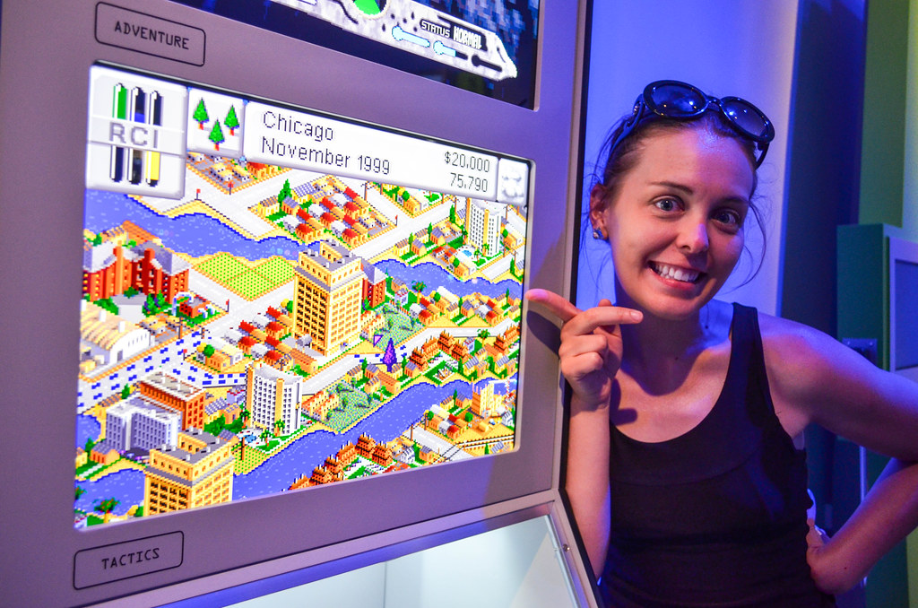 Girl point at nostalgic SimCity 2000 game