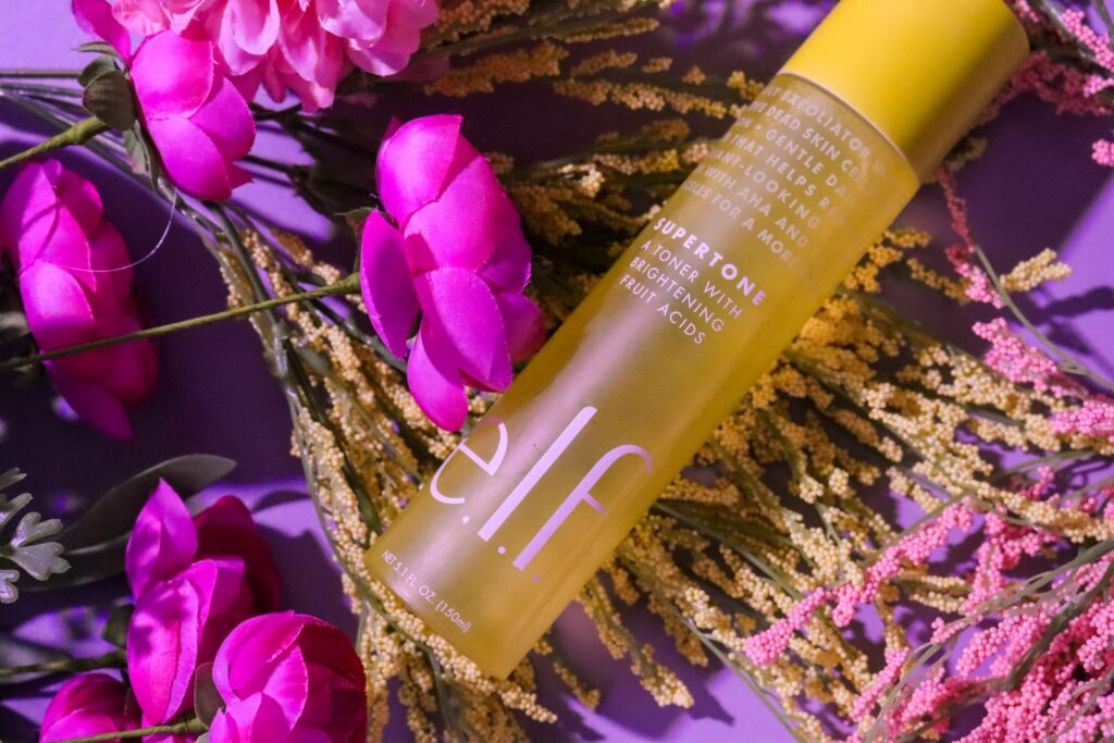 Elf Skin toner bottle with pink flowers and foliage, creating a fresh look.