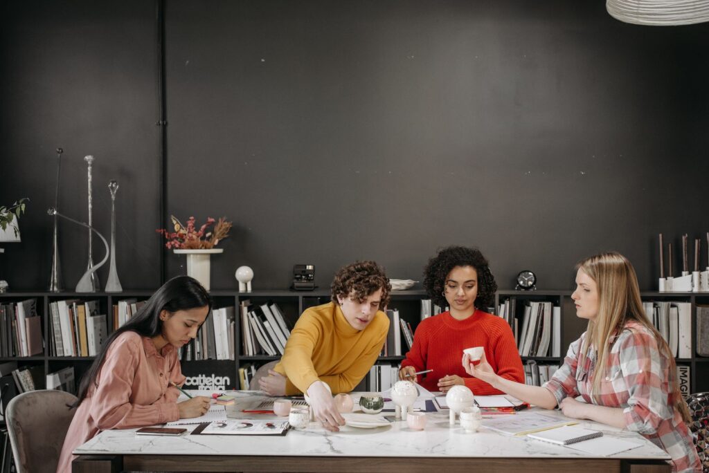 Diverse team collaborating in a stylish office space, focused on creative projects and strategy.