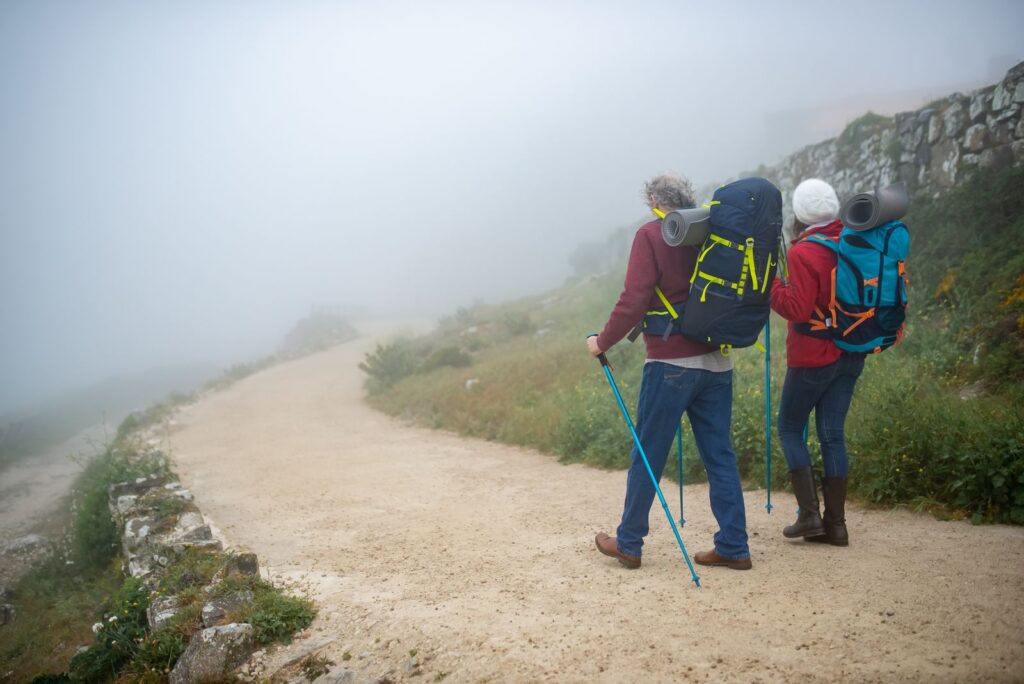 Active older couple hiking on trail