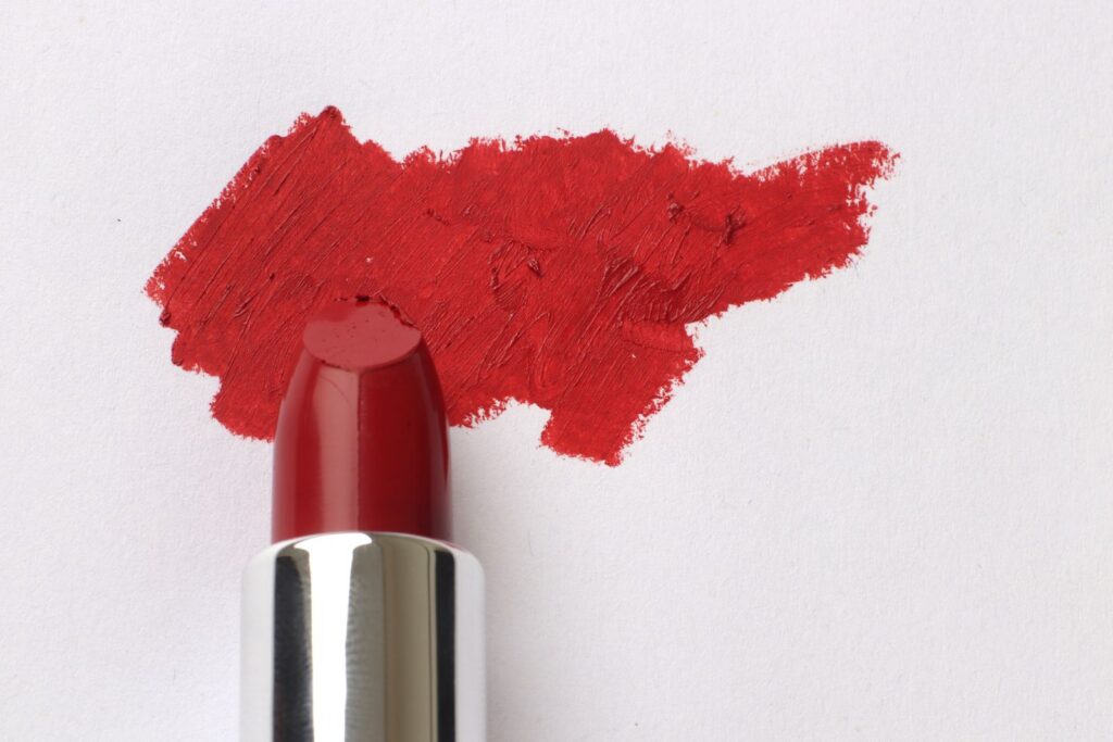 Vibrant red lipstick smear on paper for beauty and makeup themes.
