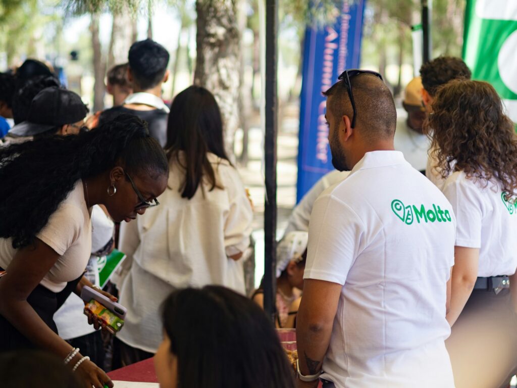 People gathered at an outdoor event, some wearing