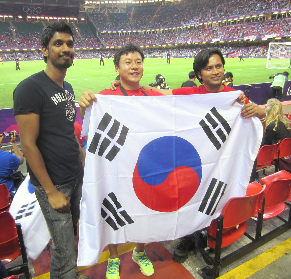 South Korean soccer fans holding flag at stadium