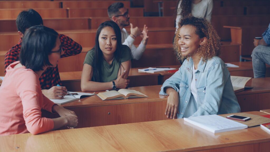 Students talking in a lecture hall during class