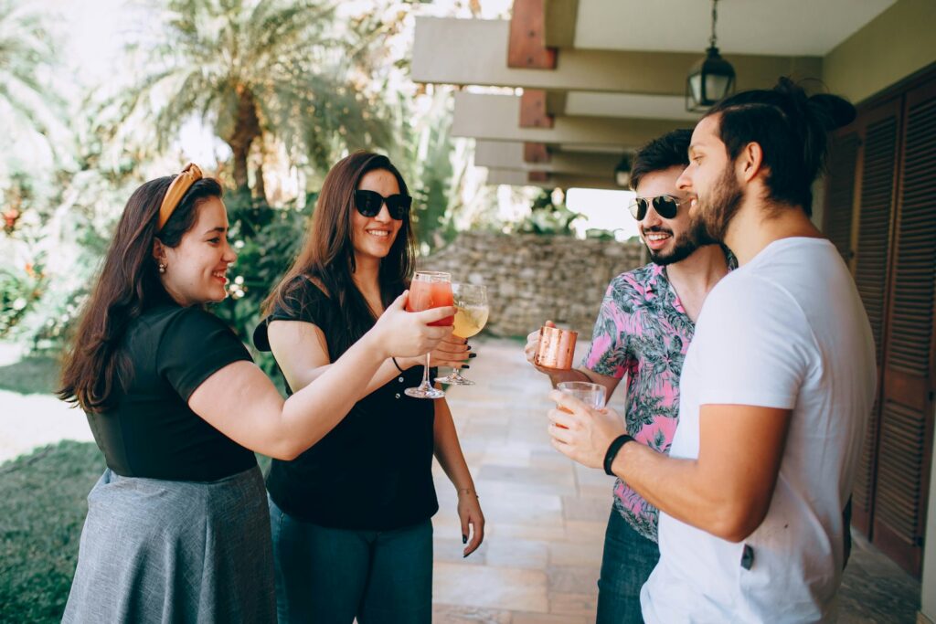 man in white crew neck t-shirt holding drinking glass