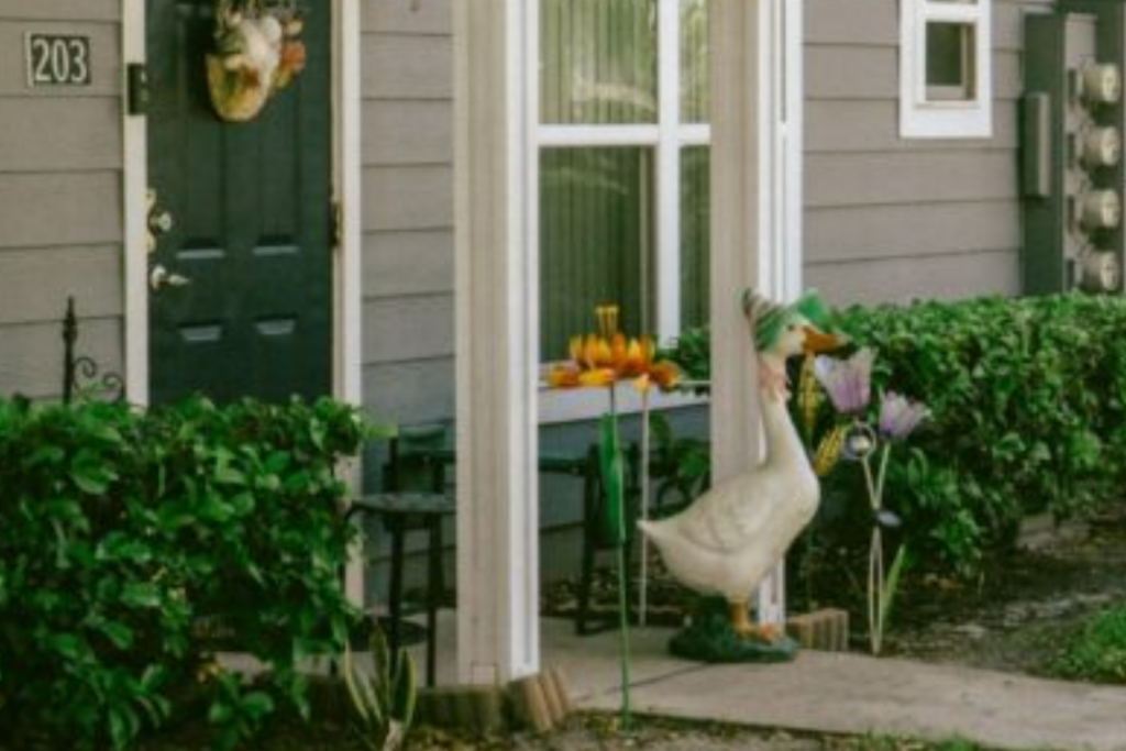 A goose statue stands by a decorated doorway