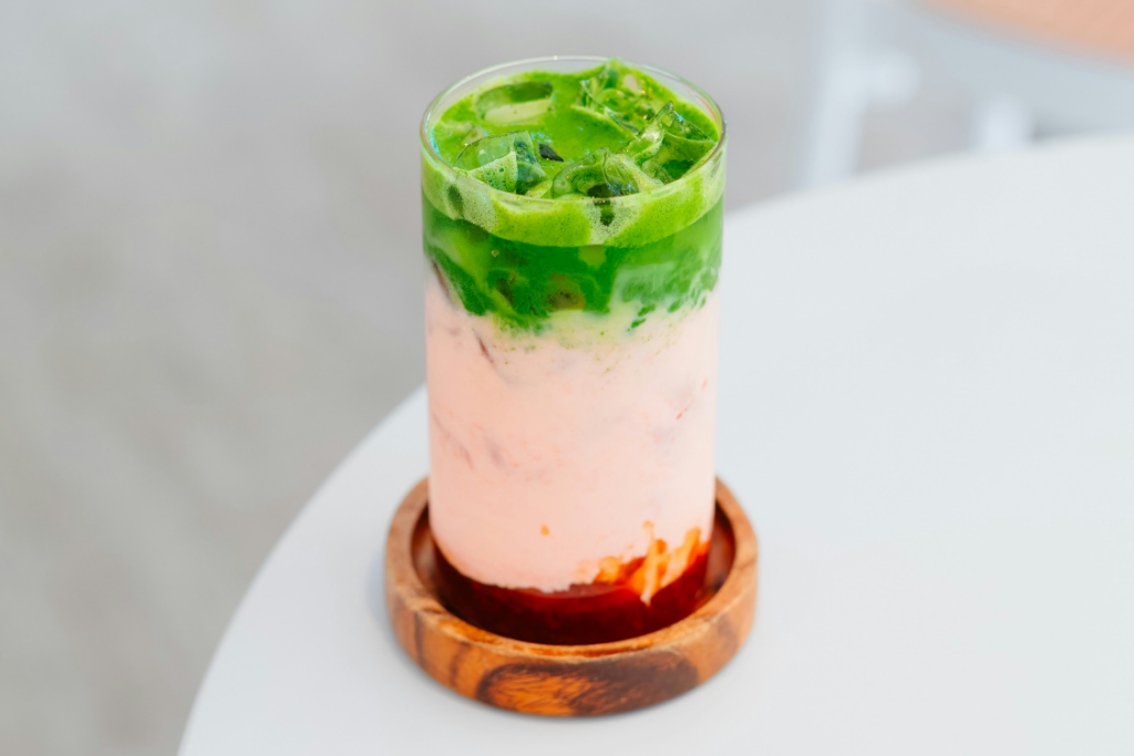 A layered matcha strawberry drink
