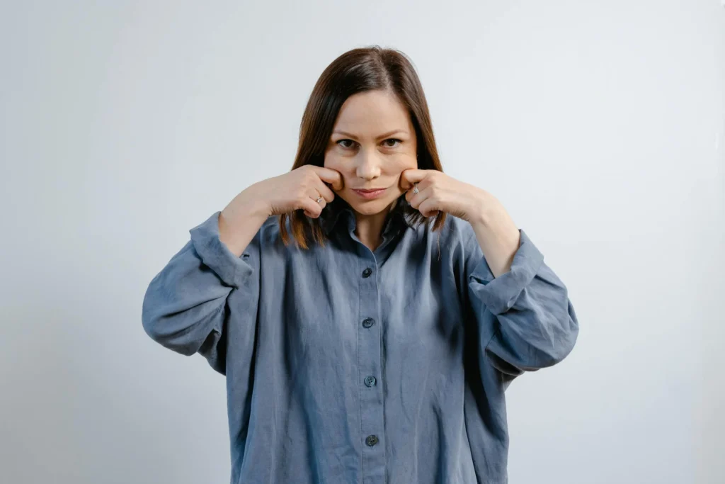 Woman doing face yoga exercise