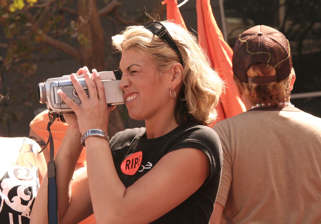 Parent holding a large shoulder camcorder