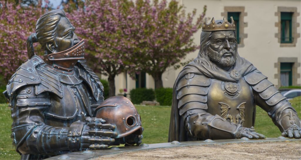 Two bronze knight statues in armor outdoors