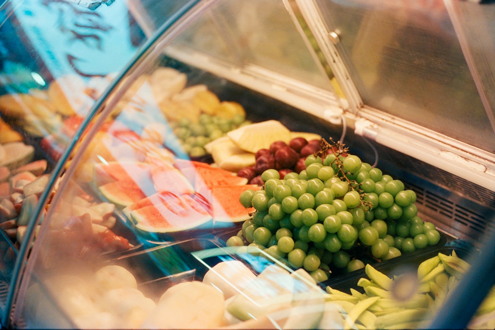 Fresh grapes and watermelon in display case