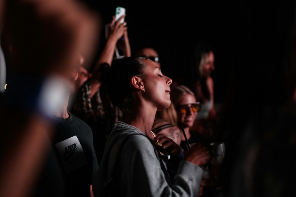 People enjoy a concert in the dark.
