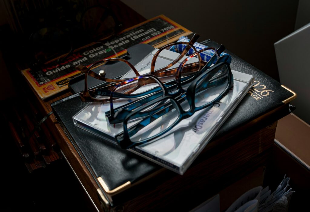 Two pairs of glasses resting on books