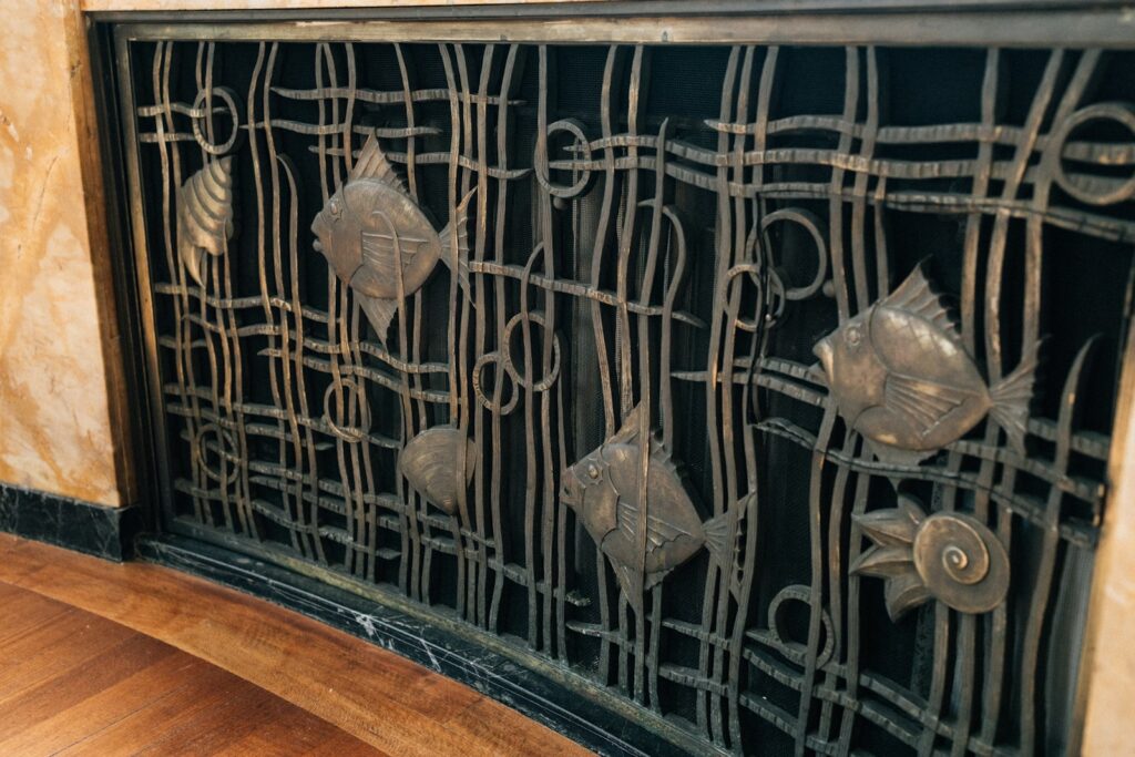 Ornate metalwork featuring fish and seaweed designs