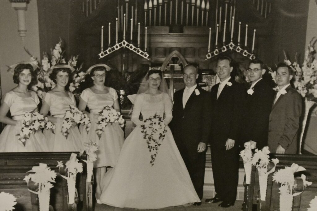 Wedding party posing in church with organ
