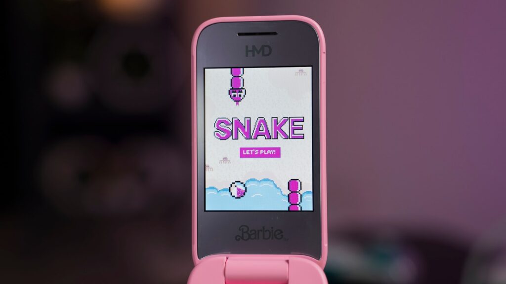 A pink smart phone with a snake on the screen