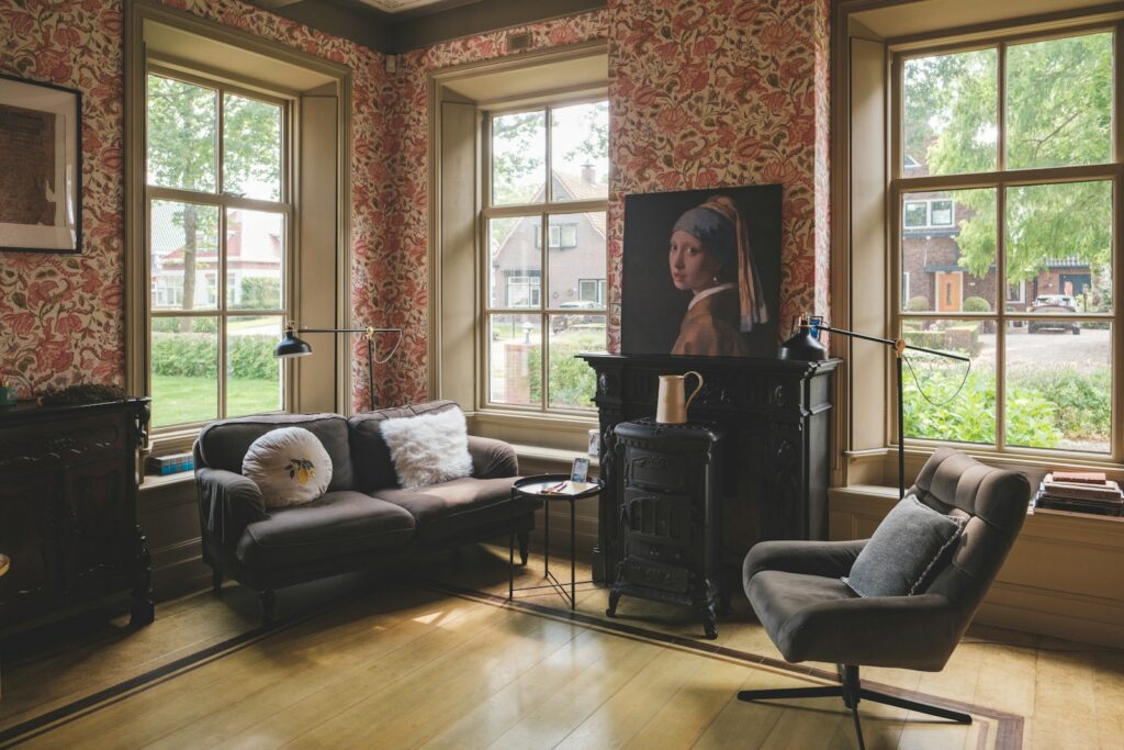 A cozy living room with an artwork on the wall.