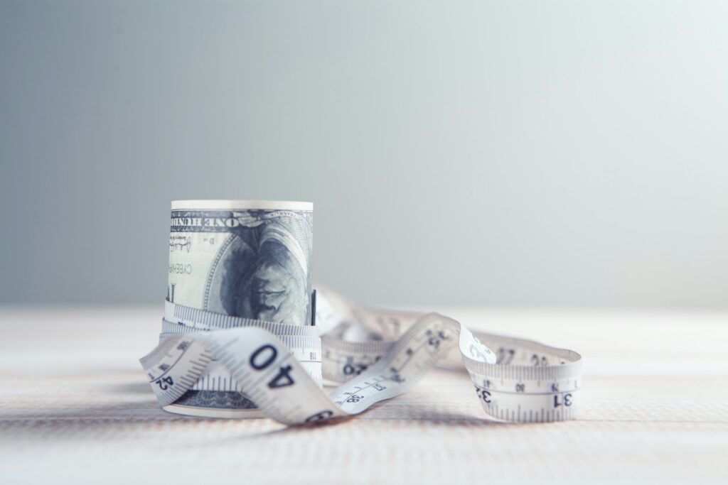a roll of one hundred dollar bills wrapped in tape