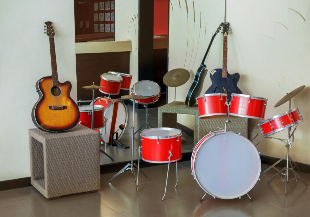 brown acoustic guitar on gray steel stand