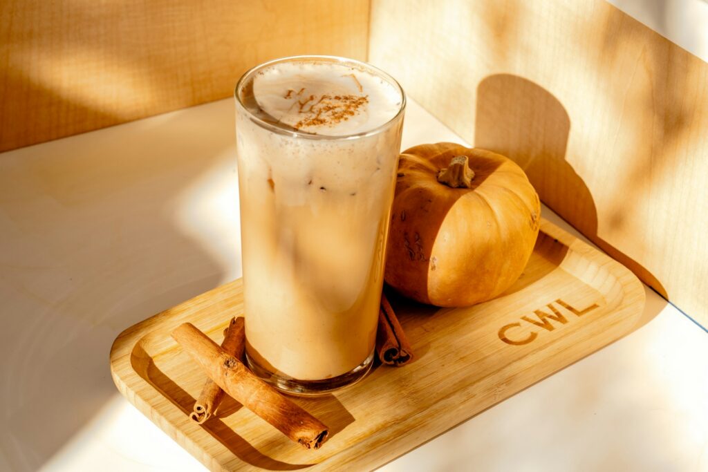 A glass of coffee sitting on top of a wooden tray