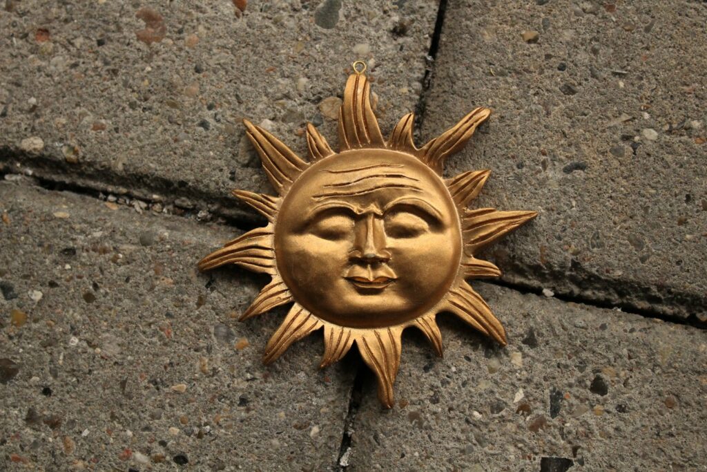 a sun face is on the sidewalk of a building