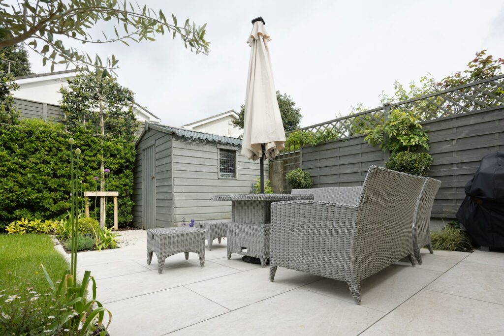A patio with a table and chairs and an umbrella