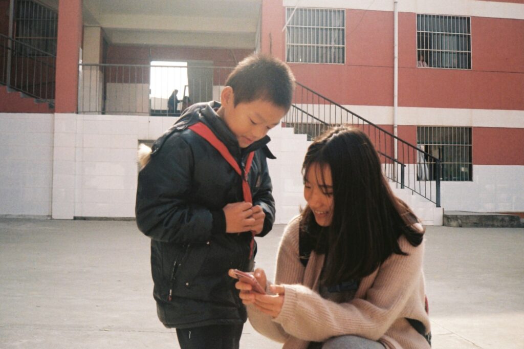 a man and a woman looking at a cell phone