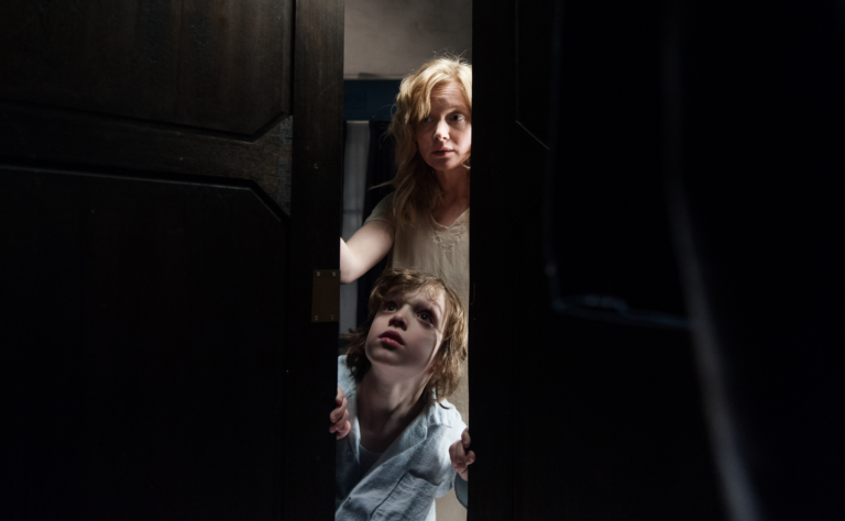 The Babadook mother and child in dark bedroom