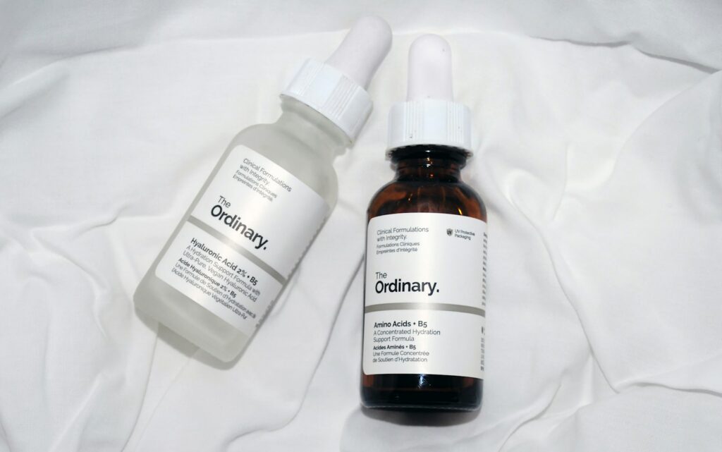 a couple of bottles of liquid sitting on top of a bed