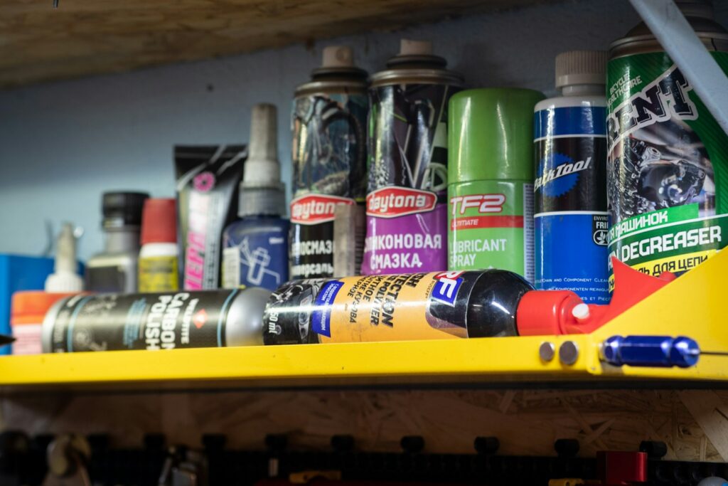 A shelf filled with lots of different types of spray paint