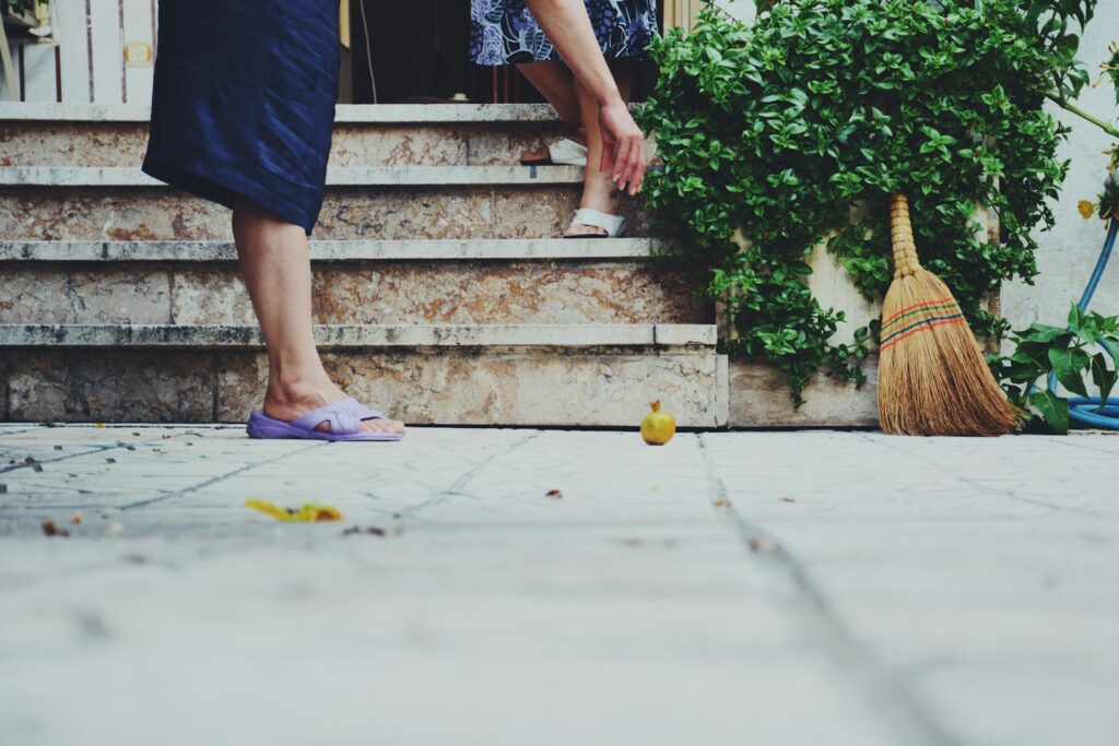 person in blue shorts standing on gray concrete floor