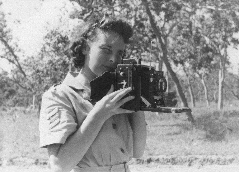 a woman holding a camera in front of her face