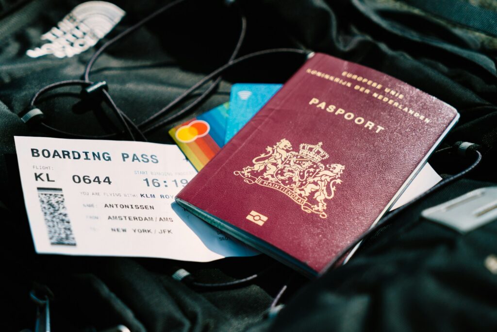 a passport and a boarding pass booked with travel rewards