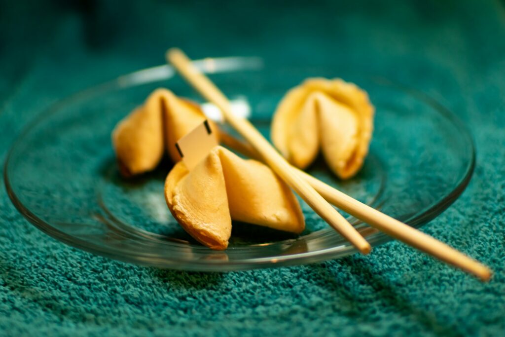A plate of dumplings with chopsticks on a green cloth