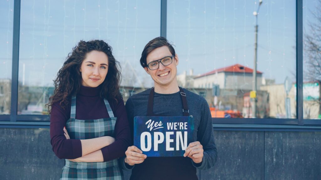 Two people stand outside with an