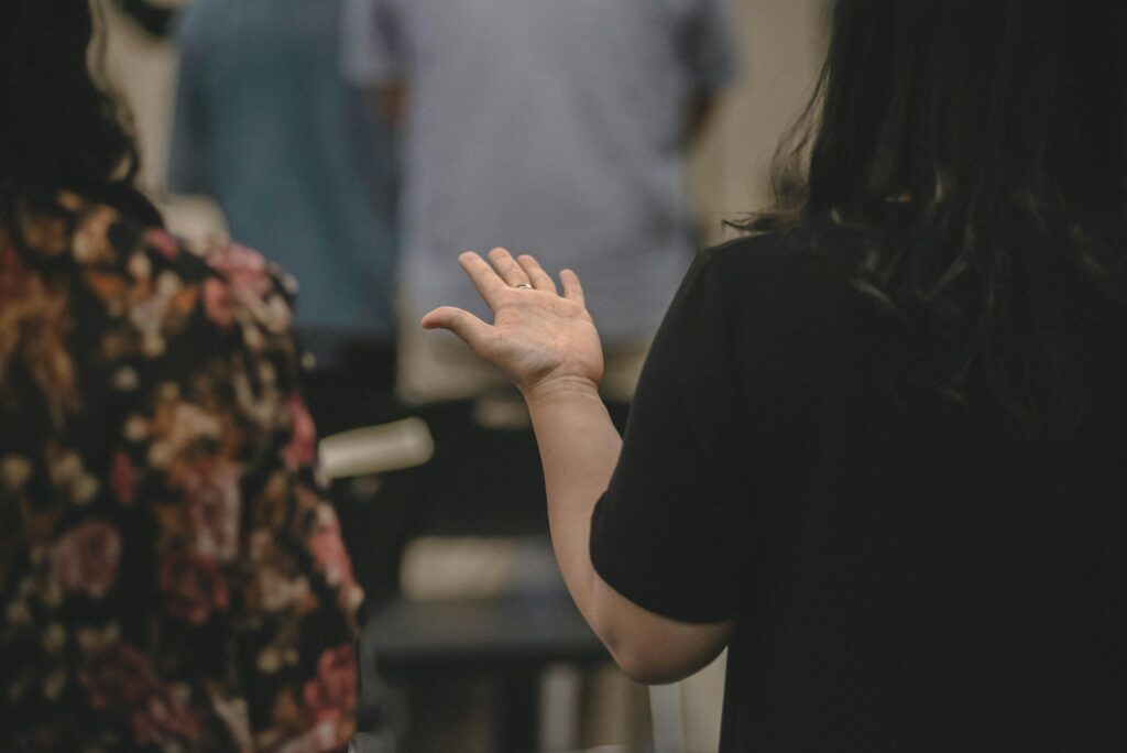 Woman raising hand in a crowd