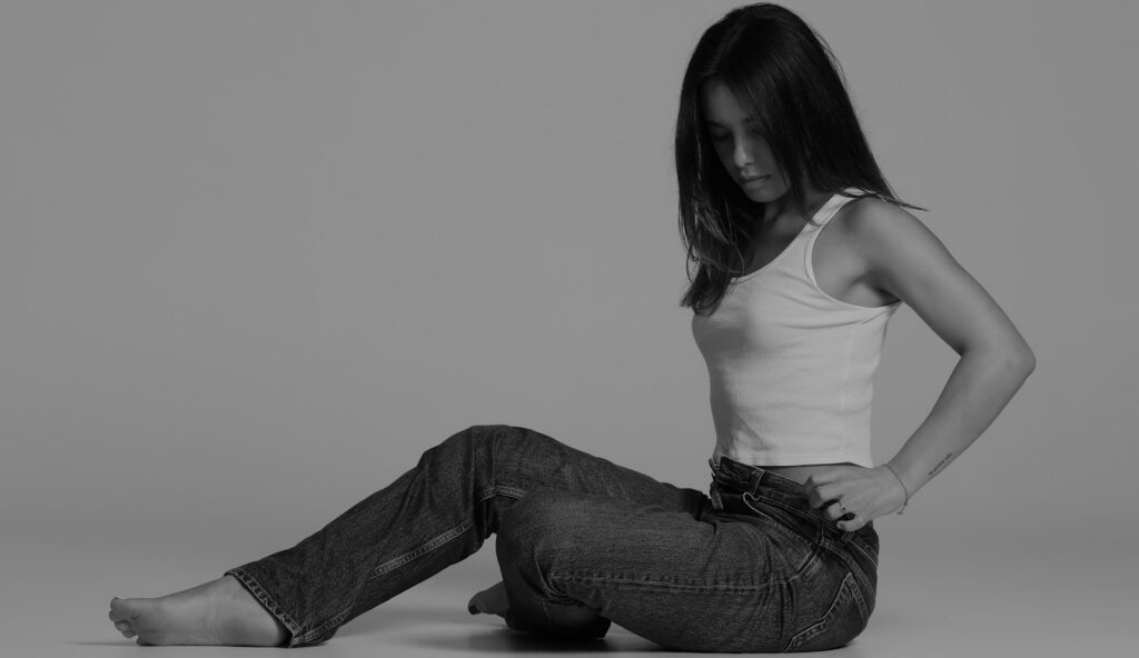 A woman is sitting on the floor.