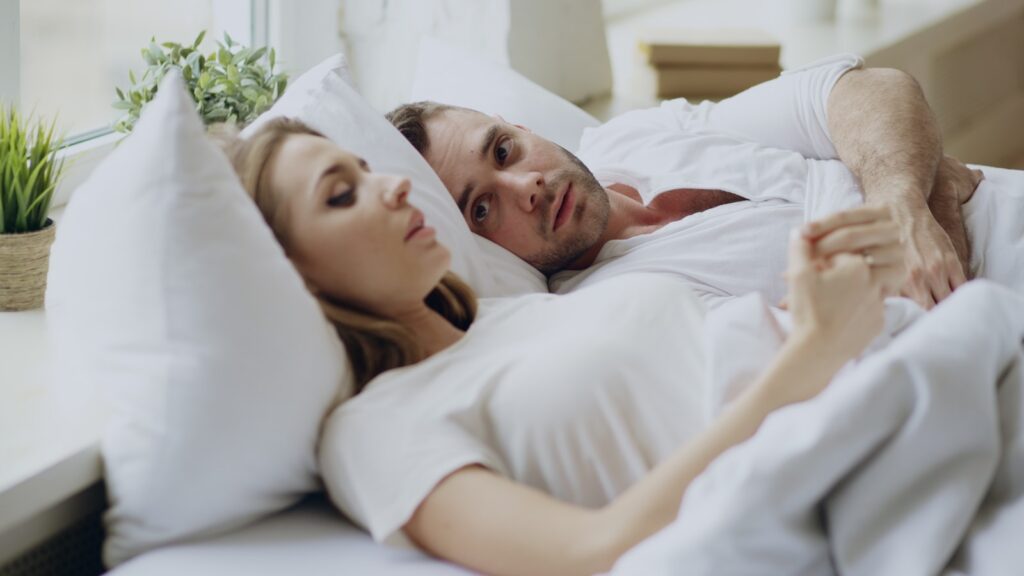 Couple lying in bed together