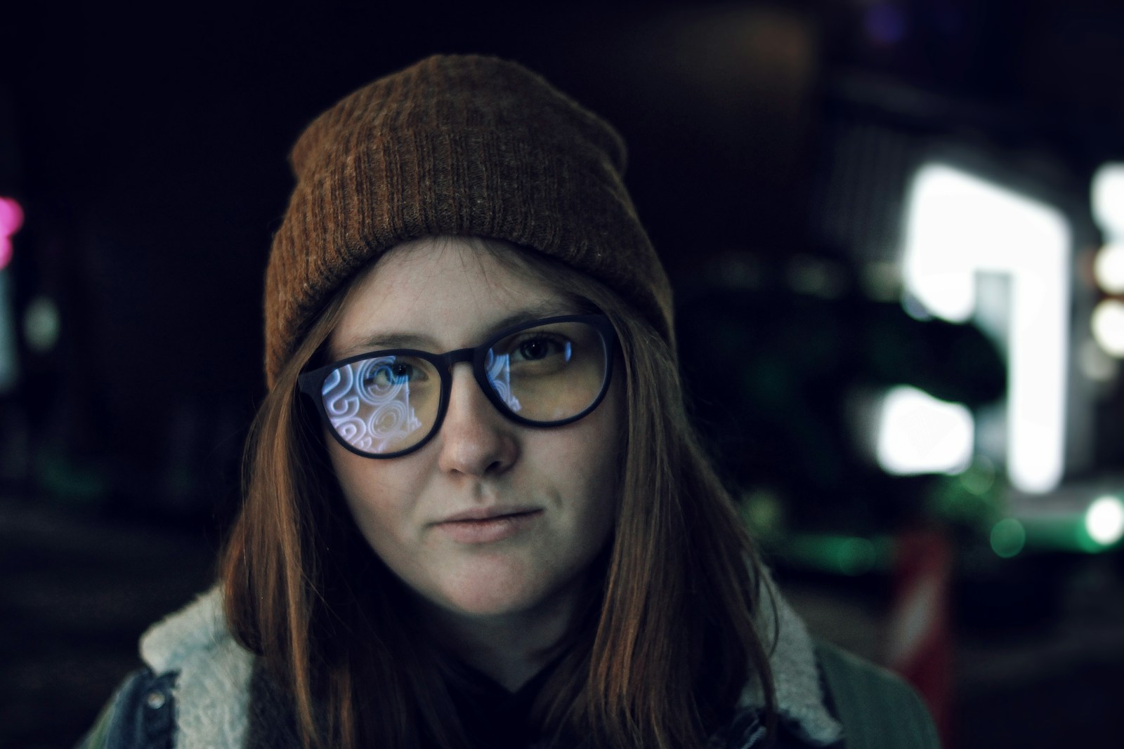 woman in black framed eyeglasses and brown knit cap