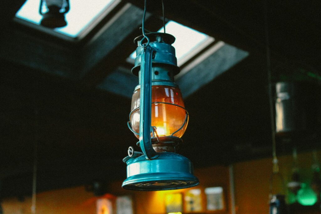 A blue light hanging from a ceiling in a room