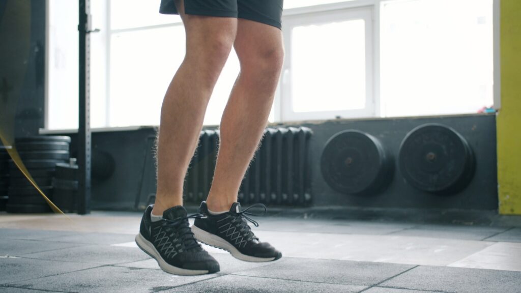 Man jumping rope in a gym.