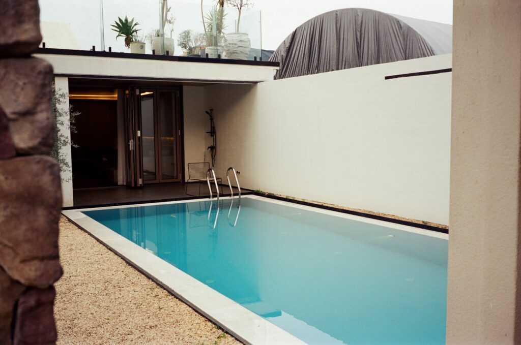 A modern swimming pool with clear blue water.