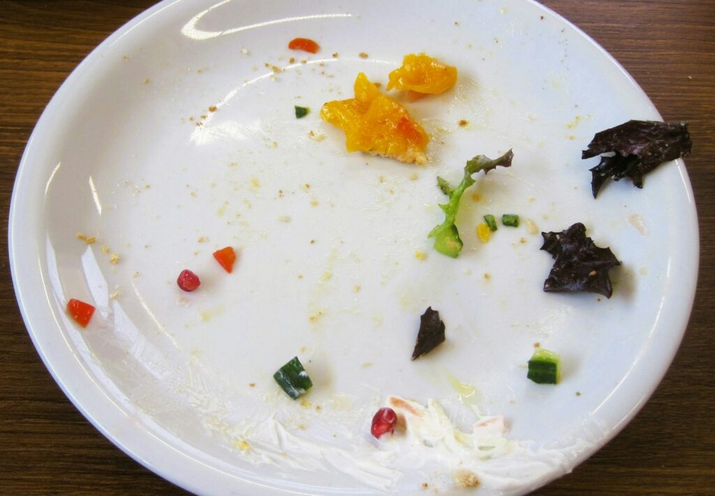 The plate shows leftover food scraps.
